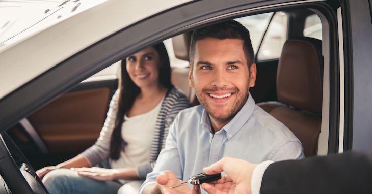 Young couple in their new car