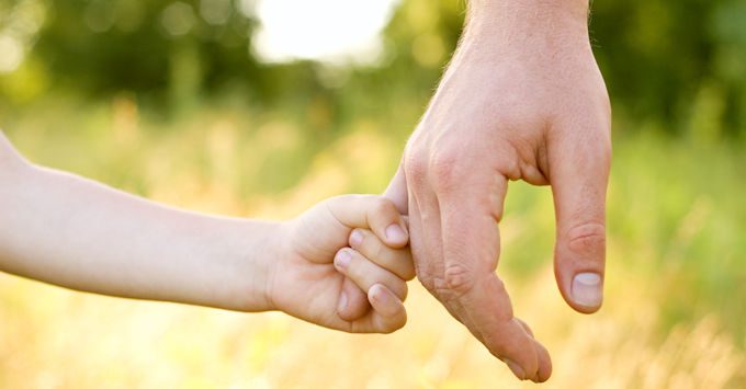 Child holding dad's hand